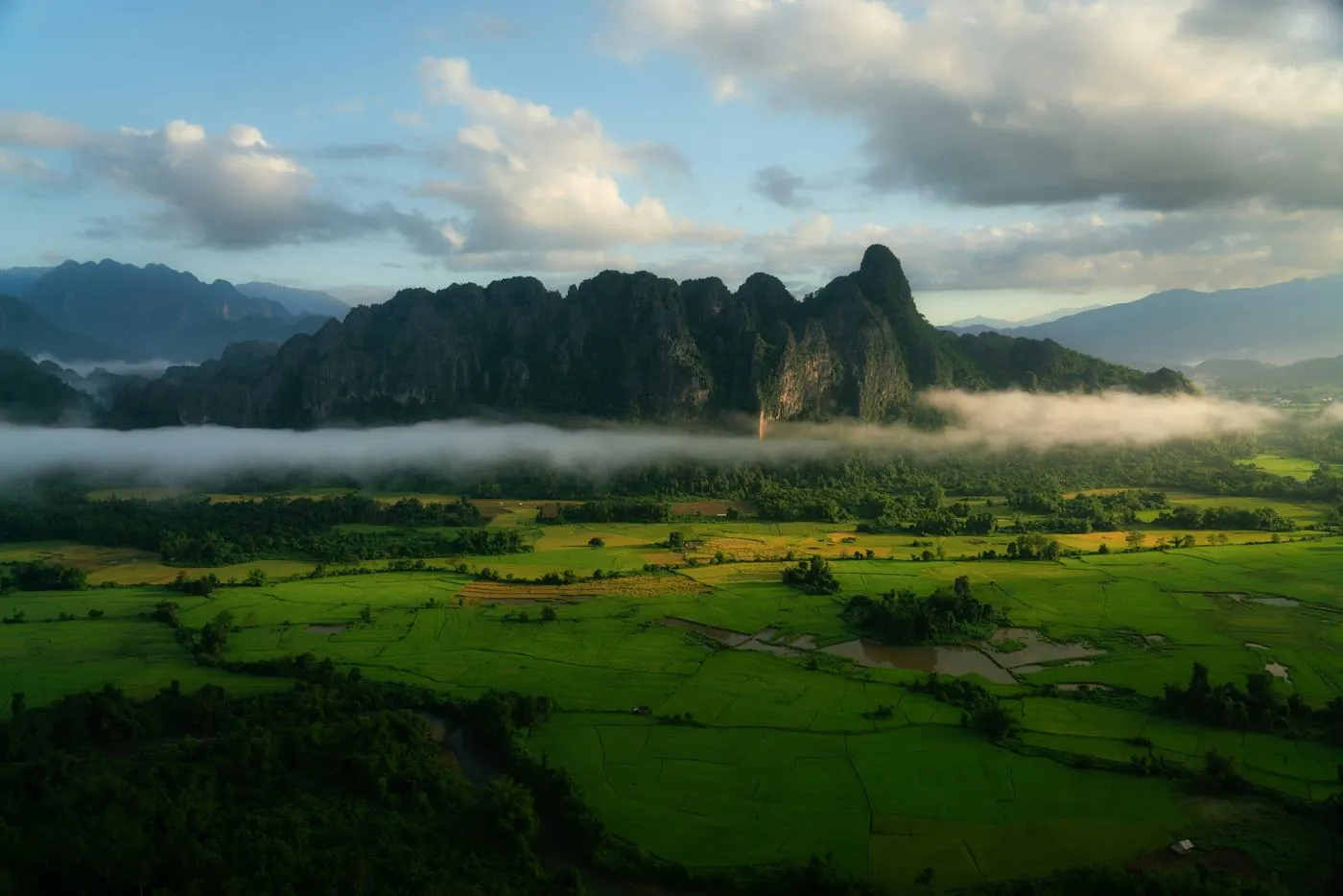 Laos Tour Package: karst mountains and rice fields near Vang Vieng