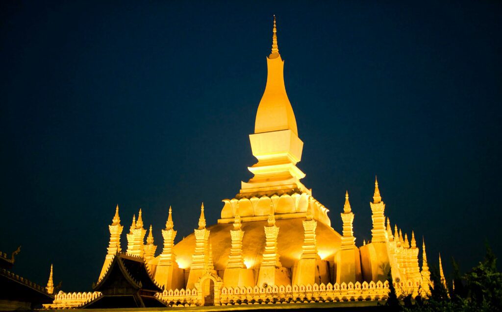 The golden stupa of Pha That Luang illuminated at night in Vientiane, Laos